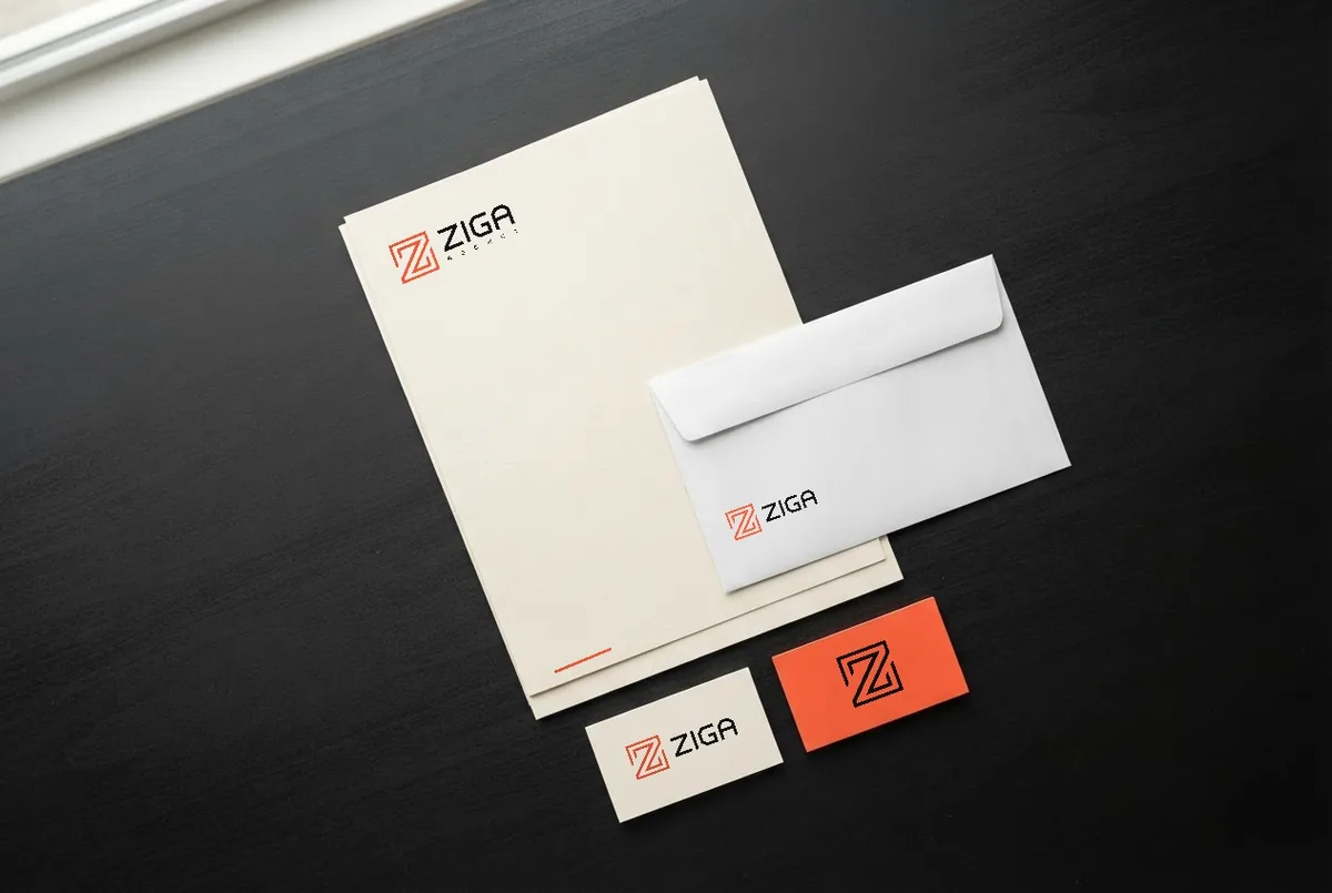 Papelaria da Ziga Agency: cartões e envelopes em creme com o símbolo coral